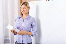 Young teacher standing in the classroom. — Stock Photo © yacobchuk1  #91527366