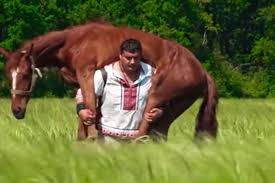 Man carries horse, bites through metal to prove his strength